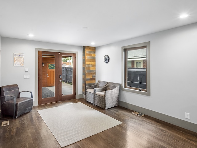 living area featuring dark hardwood / wood-style floors and french doors