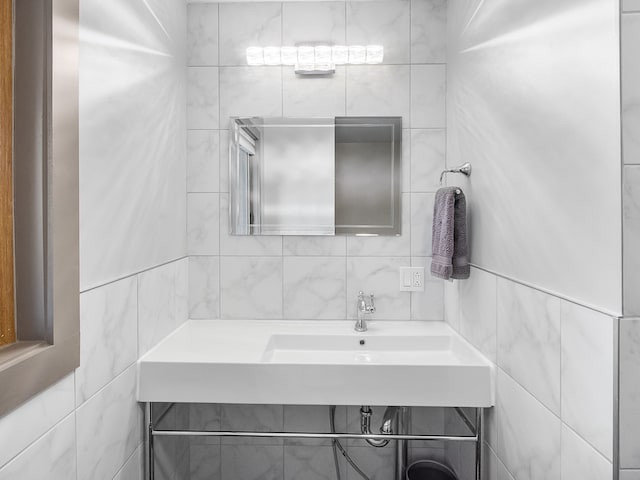 bathroom featuring tile walls and vanity