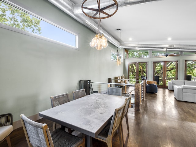 dining area featuring dark hardwood / wood-style floors, a chandelier, and french doors