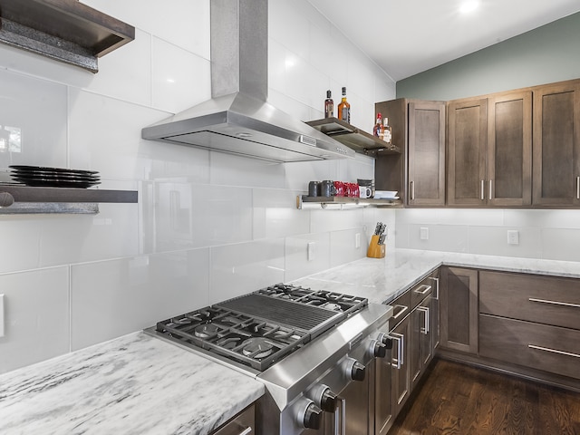 kitchen with island range hood, stainless steel stove, dark hardwood / wood-style flooring, and tasteful backsplash