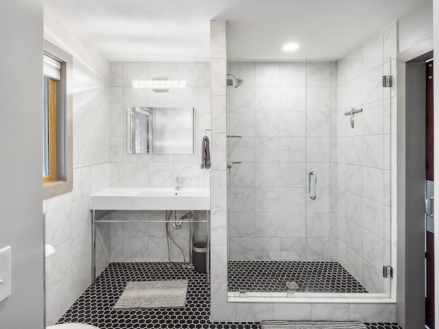 bathroom with tile walls and walk in shower