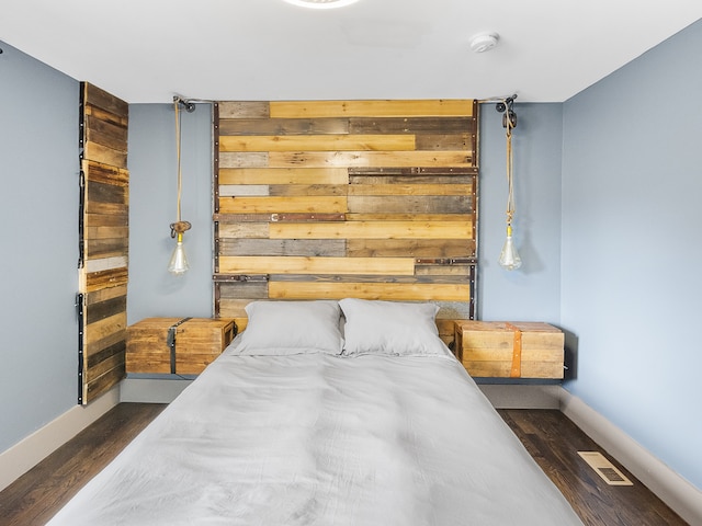 bedroom featuring dark hardwood / wood-style flooring