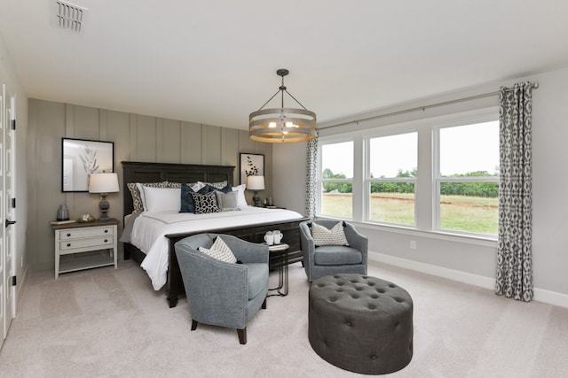 carpeted bedroom with multiple windows and an inviting chandelier