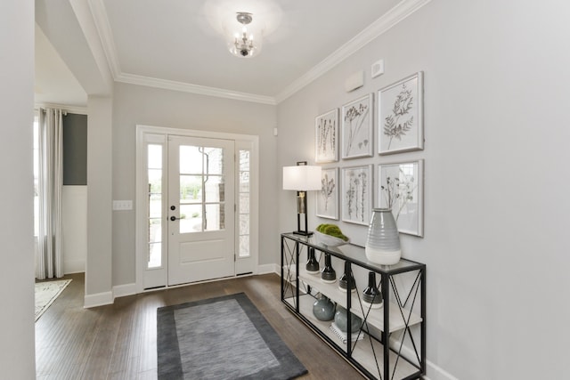 foyer featuring ornamental molding, dark hardwood / wood-style floors, and an inviting chandelier