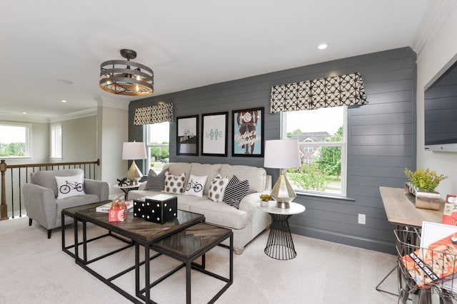 living room with light colored carpet, crown molding, and wood walls