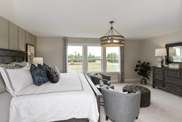 carpeted bedroom featuring a chandelier