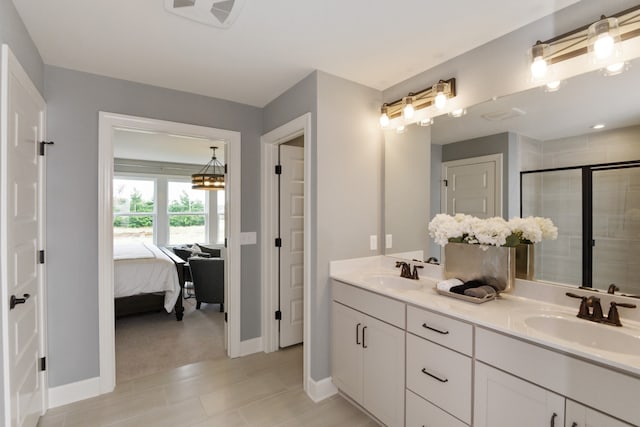 bathroom featuring tile patterned flooring, walk in shower, and vanity