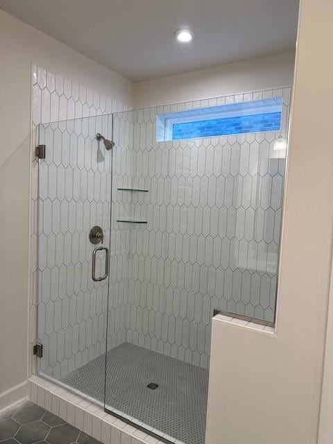 bathroom with tile patterned floors and an enclosed shower