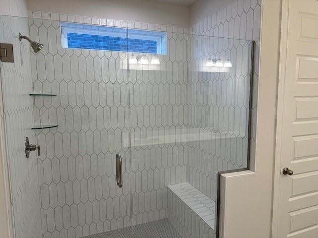 bathroom with a shower with shower door