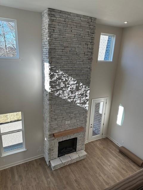 unfurnished living room with a fireplace and wood-type flooring