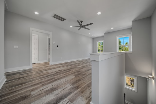 empty room with wood-type flooring and ceiling fan