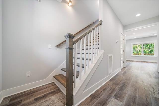 stairs with hardwood / wood-style floors