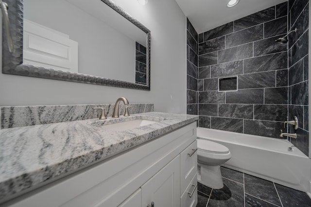 full bathroom with tiled shower / bath, vanity, toilet, and tile patterned flooring