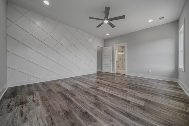 unfurnished bedroom featuring ensuite bath, wood-type flooring, and ceiling fan