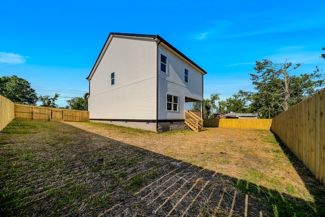 rear view of house featuring a yard