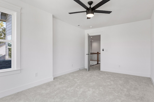 carpeted empty room featuring ceiling fan