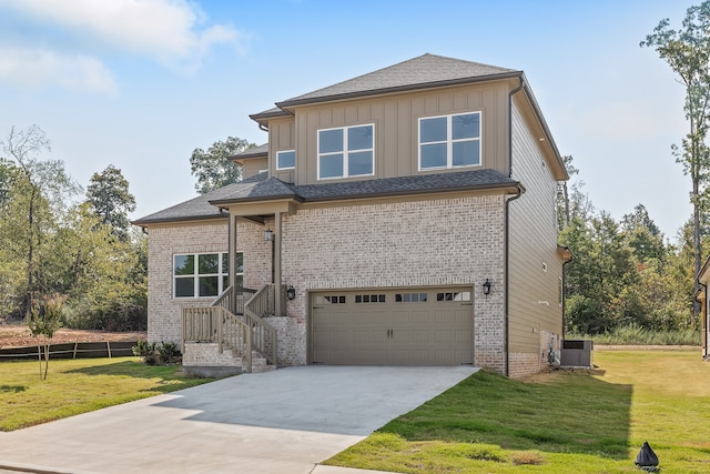 view of front of house with a garage, a front lawn, and central air condition unit