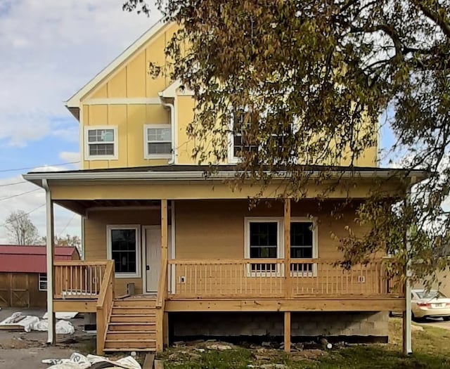 rear view of house featuring covered porch