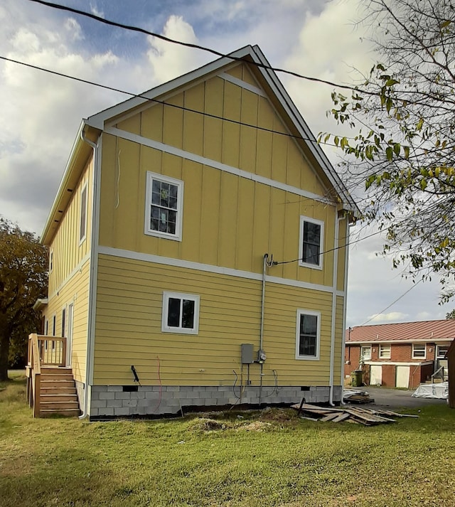 view of home's exterior with a lawn