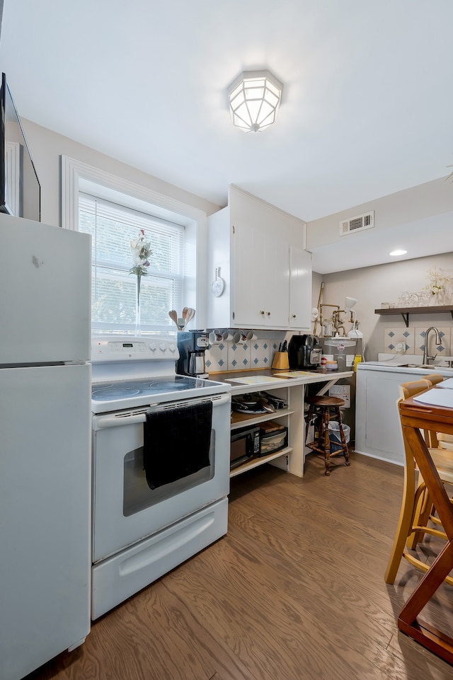 kitchen featuring light hardwood / wood-style flooring, white appliances, white cabinetry, sink, and decorative backsplash