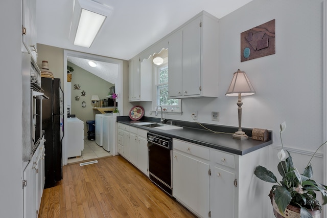 kitchen with light hardwood / wood-style flooring, black appliances, white cabinets, and separate washer and dryer