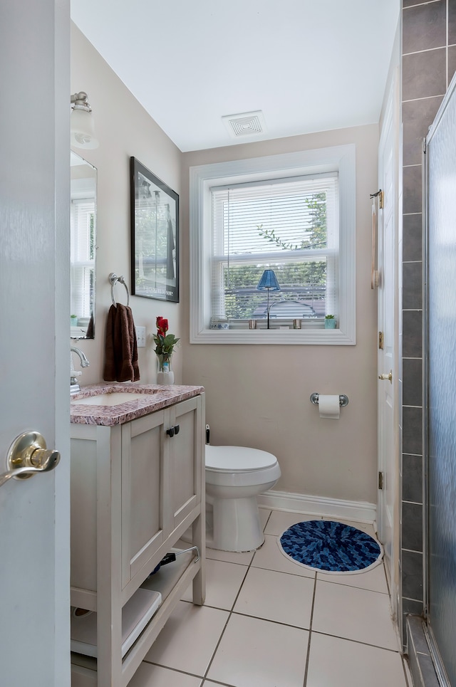 bathroom with vanity, toilet, an enclosed shower, and tile patterned floors