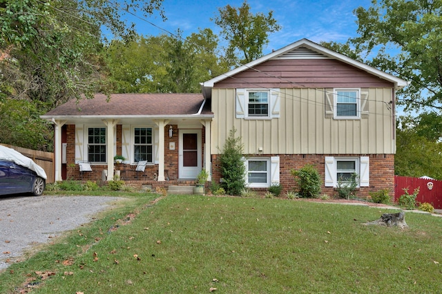 split level home with a front yard and covered porch