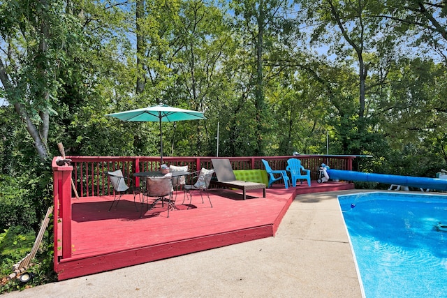 view of swimming pool with a deck