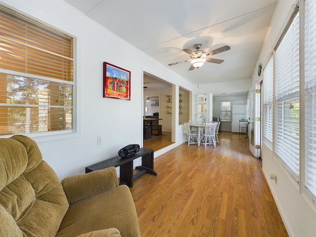 living room with hardwood / wood-style flooring, a wealth of natural light, and ceiling fan