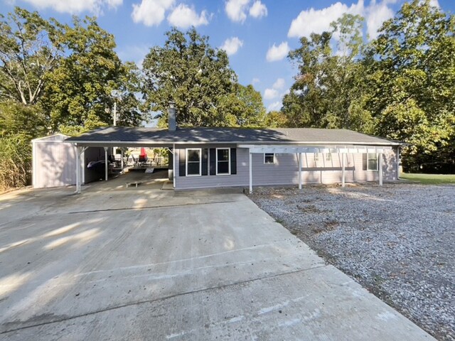 ranch-style house featuring a carport