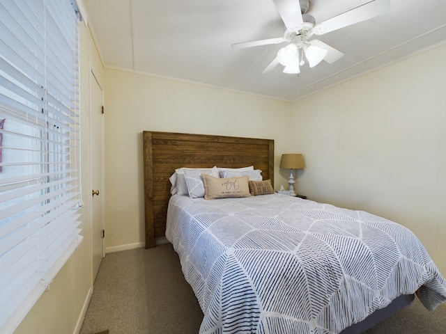 bedroom with crown molding, ceiling fan, and carpet floors