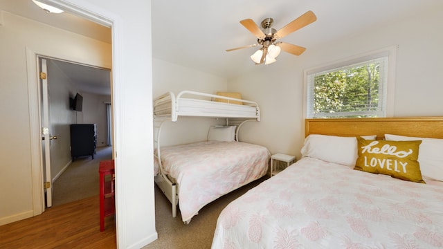 bedroom featuring hardwood / wood-style floors and ceiling fan