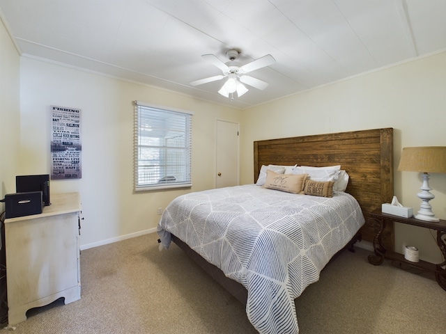 bedroom featuring light colored carpet, ceiling fan, and ornamental molding