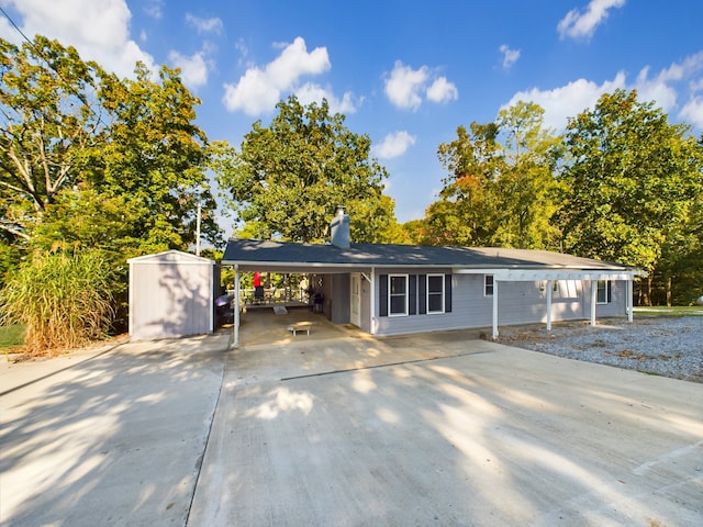 ranch-style house with a storage unit