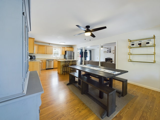 dining space with hardwood / wood-style flooring and ceiling fan