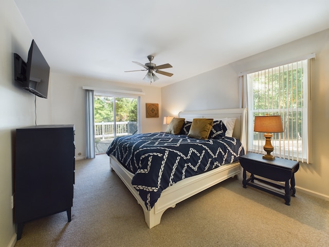 bedroom with access to exterior, ceiling fan, and carpet flooring