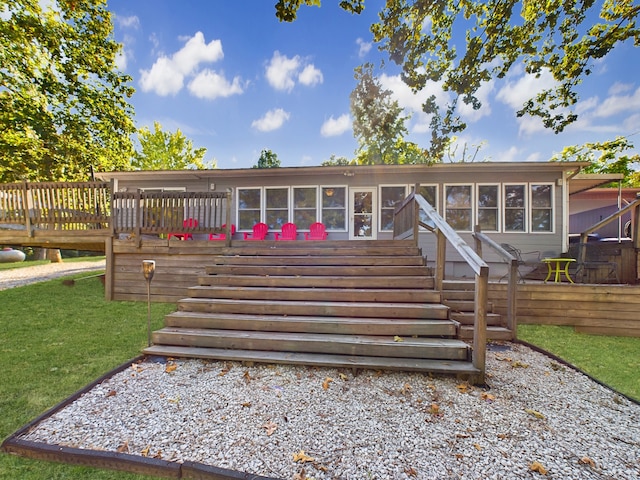 exterior space featuring a sunroom and a deck