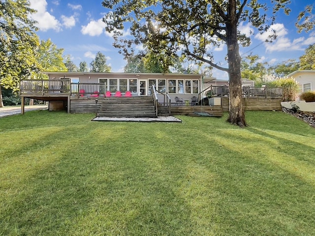 back of property with a wooden deck and a yard