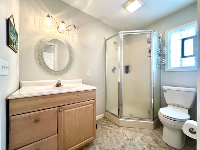 bathroom featuring a shower with shower door, toilet, and vanity