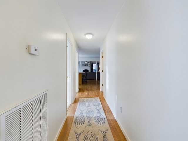 hall with light hardwood / wood-style flooring