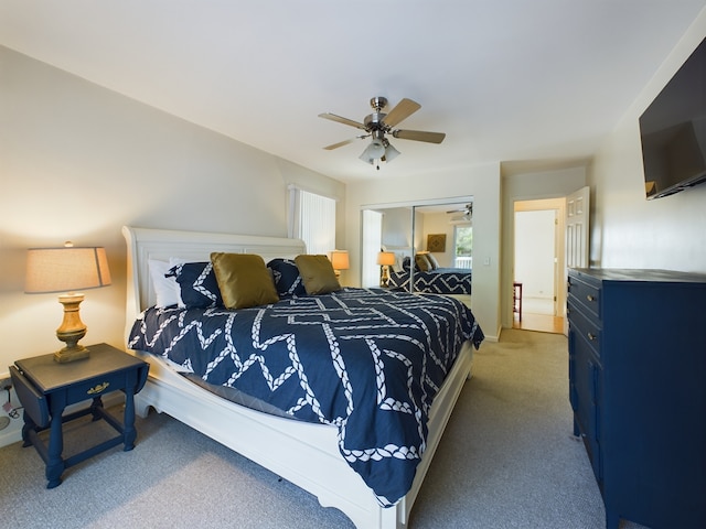 bedroom with a closet, ceiling fan, and carpet