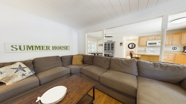 living room featuring ceiling fan, light wood-type flooring, wooden ceiling, and decorative columns