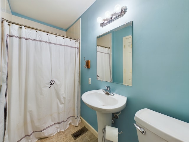 bathroom with toilet and walk in shower