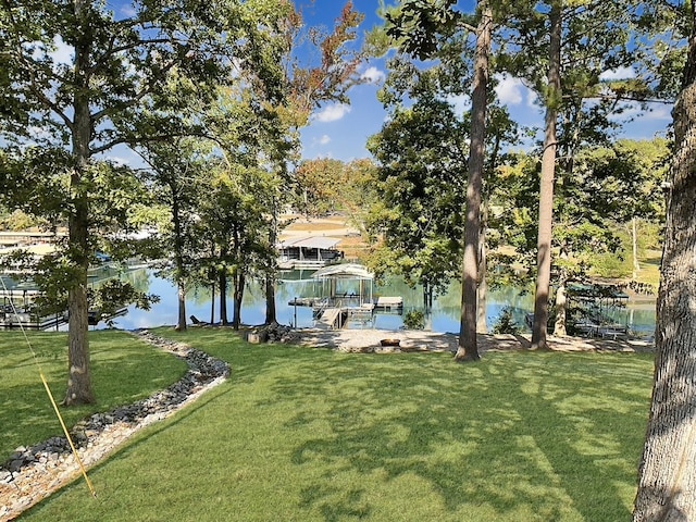 exterior space featuring a boat dock and a water view