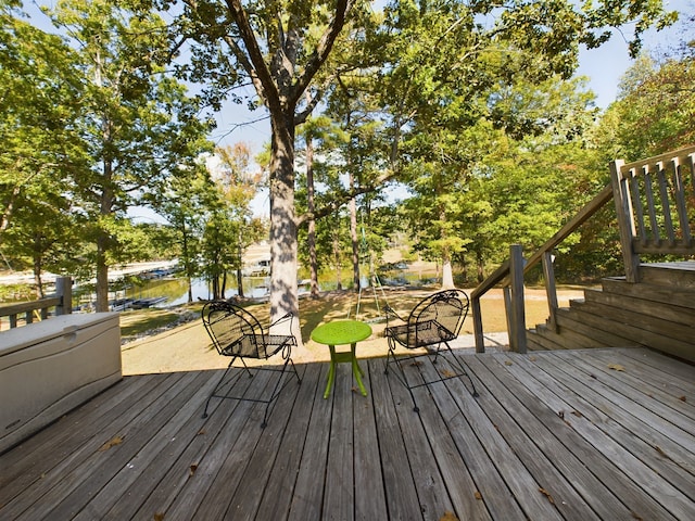 wooden deck featuring a water view