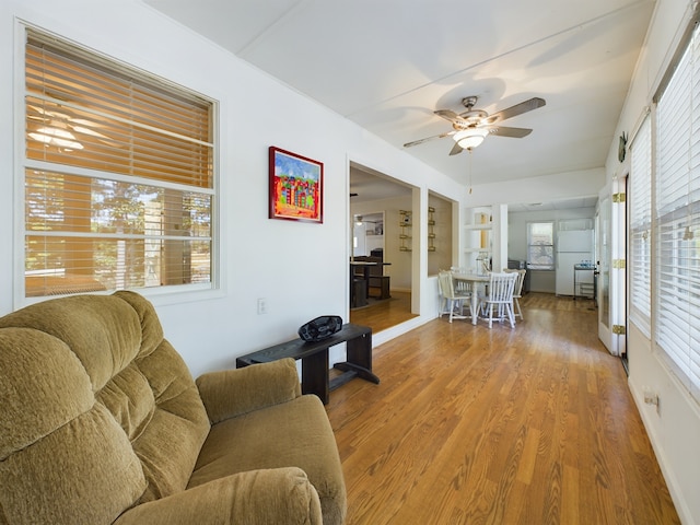 living room with plenty of natural light, ceiling fan, and hardwood / wood-style flooring