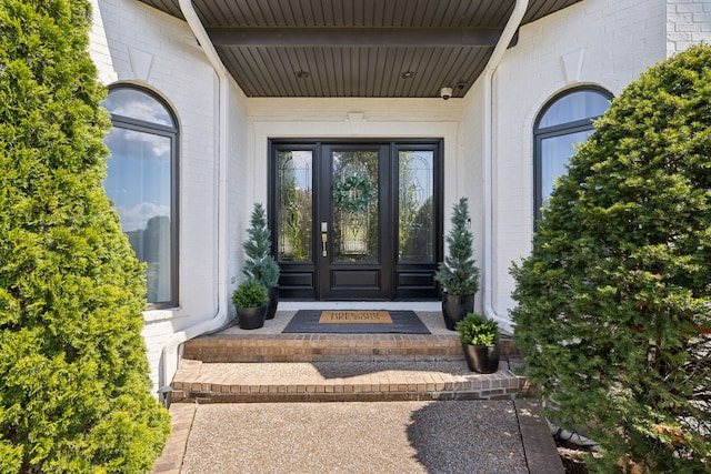 view of exterior entry with a porch