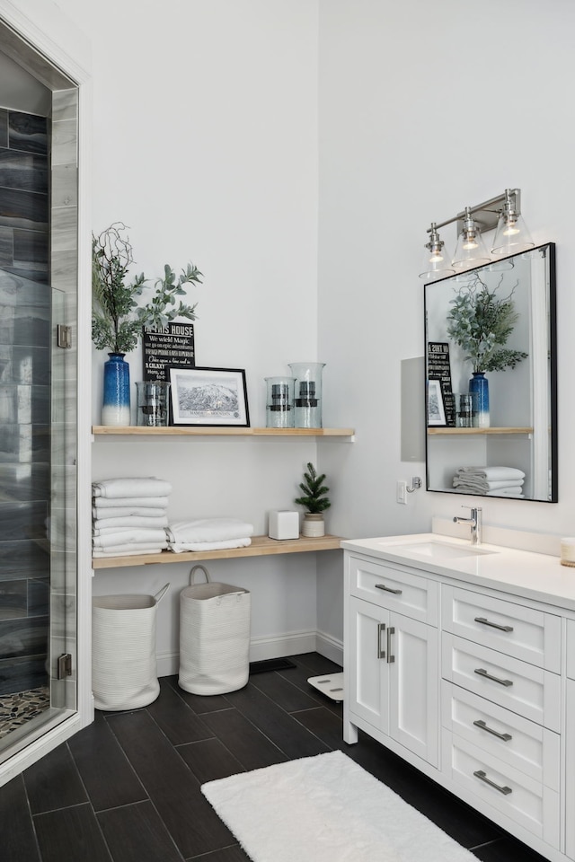 bathroom featuring vanity and a shower with door