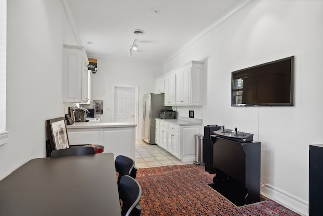 kitchen featuring white cabinets, ornamental molding, and light tile patterned flooring