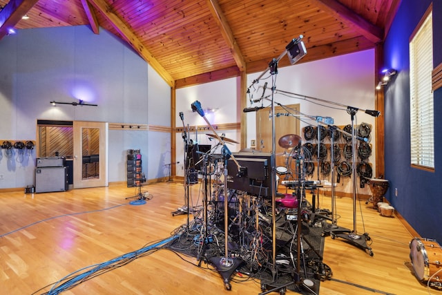 exercise room featuring hardwood / wood-style floors, wood ceiling, and high vaulted ceiling